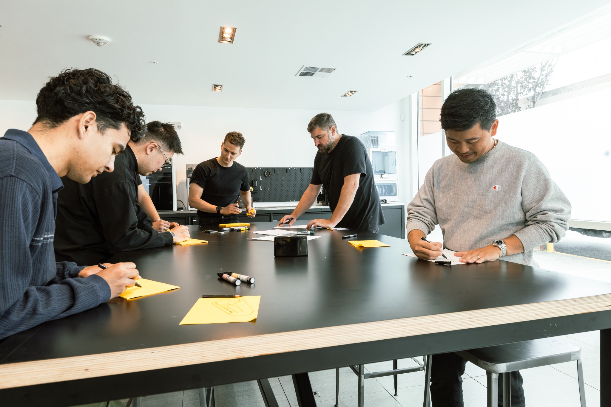 Designers sketching together at the workshop table
