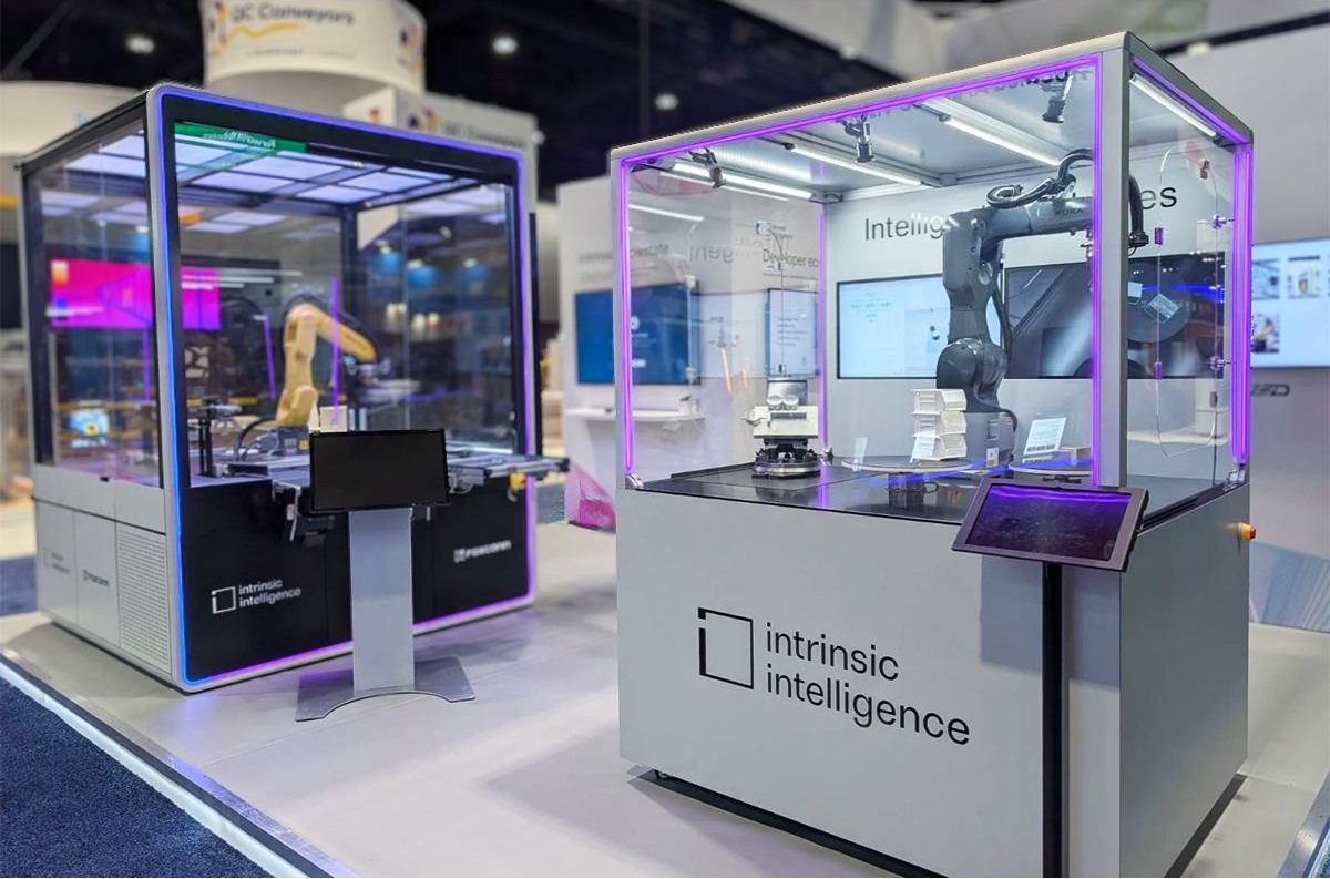 Original trade-show photograph of the built Intrinsic robot enclosure designed by Huge Design, on the left