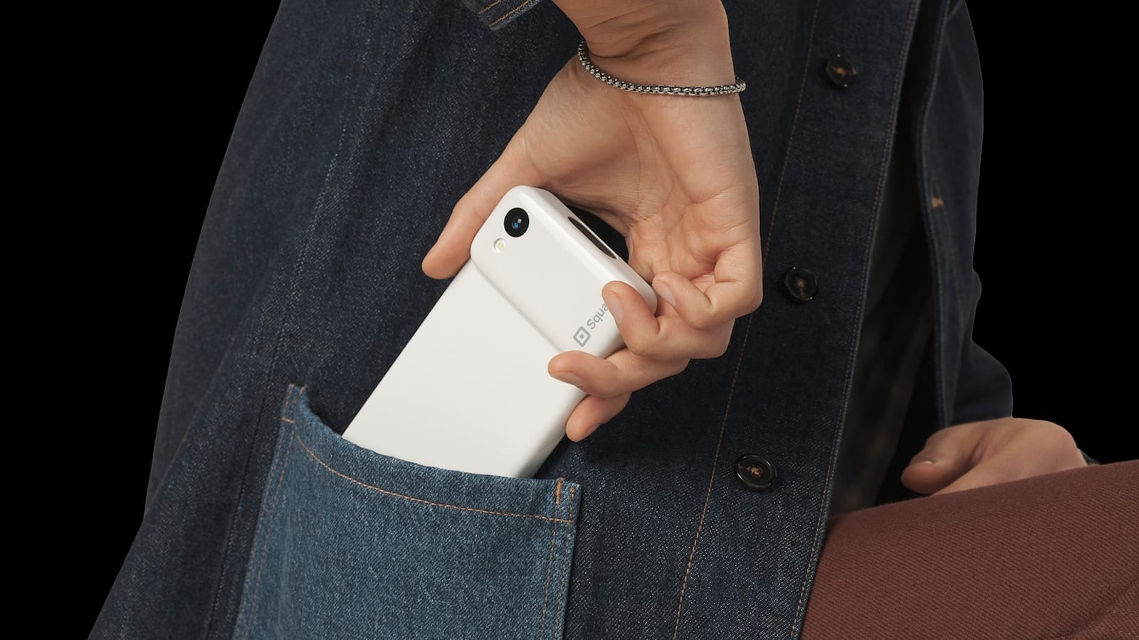 Square Handheld slipping into a pocket