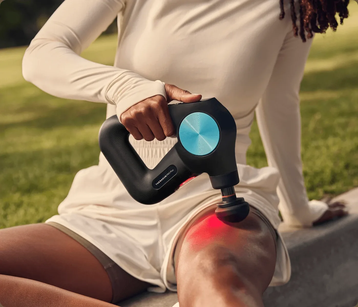 Therabody Theragun handheld recovery device in use